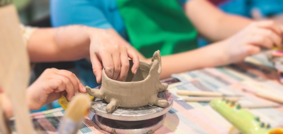 Pottery lesson master class for kids children, process of making clay pot on pottery wheel, potter wet hands creating ceramic crockery handcrafts, ceramist molding jar or vase